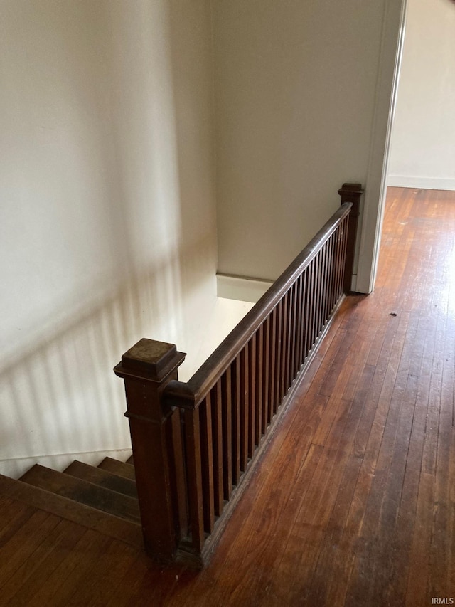 staircase with hardwood / wood-style floors