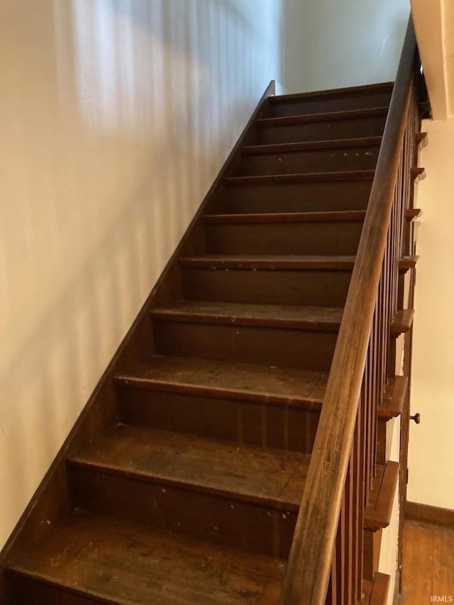 stairs featuring wood-type flooring