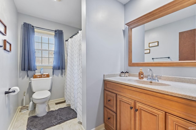 bathroom featuring tile patterned floors, vanity, and toilet