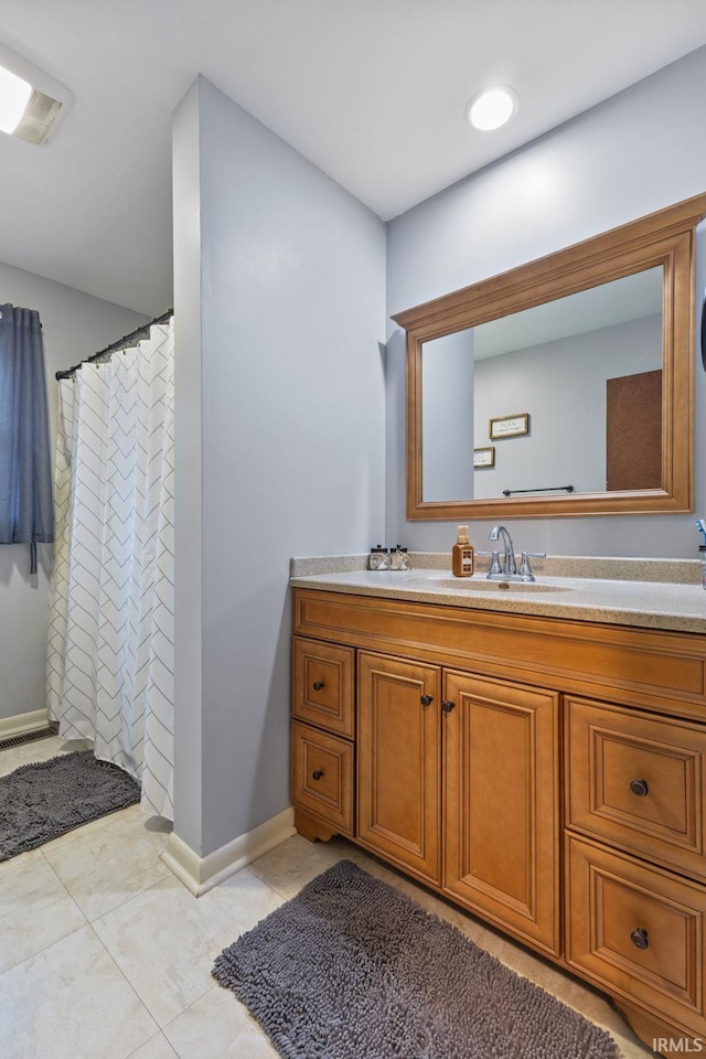 bathroom featuring tile patterned floors, a shower with curtain, and vanity