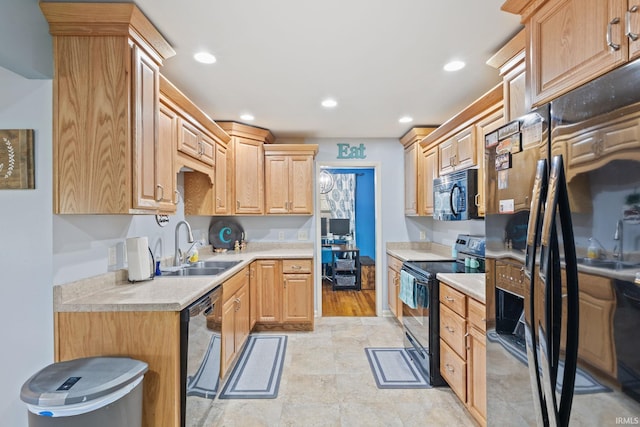 kitchen featuring black appliances, sink, and light brown cabinetry