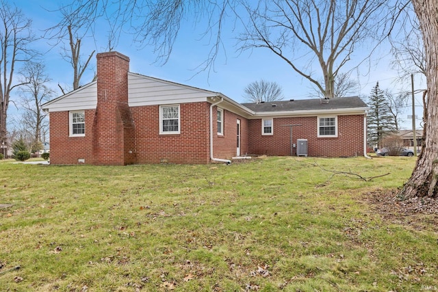 rear view of house featuring a yard and cooling unit