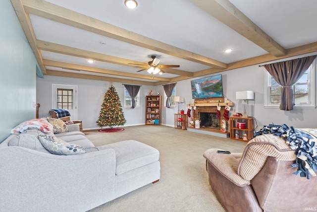 living room featuring carpet flooring, beam ceiling, and ceiling fan