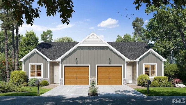 view of front of property with a garage, concrete driveway, stone siding, roof with shingles, and board and batten siding