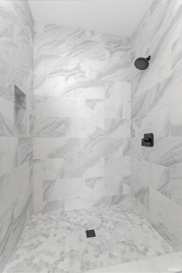 bathroom with a tile shower