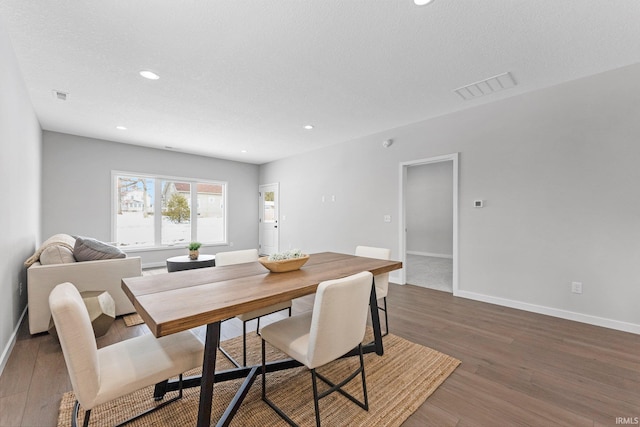 dining space featuring dark wood-style floors, baseboards, visible vents, and recessed lighting