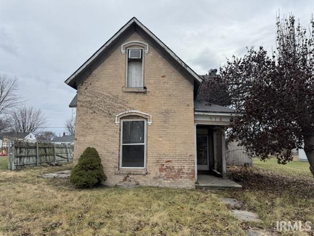 rear view of house featuring a lawn