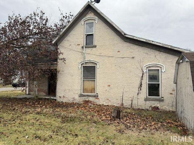 view of property exterior featuring a lawn