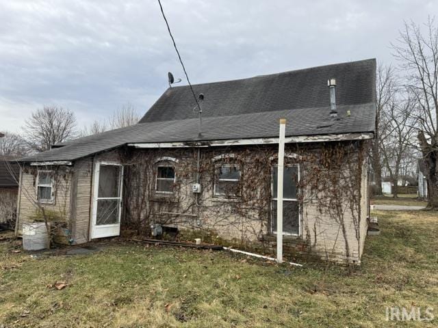 rear view of property with a yard