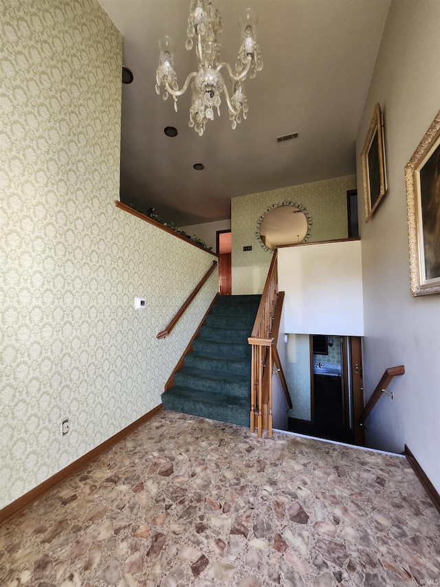 stairs with an inviting chandelier