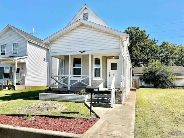 bungalow-style house with a front lawn and a porch