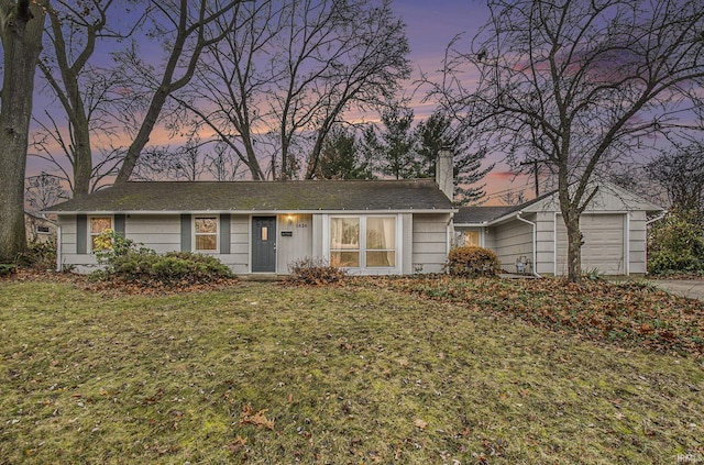 ranch-style home with a lawn and a garage