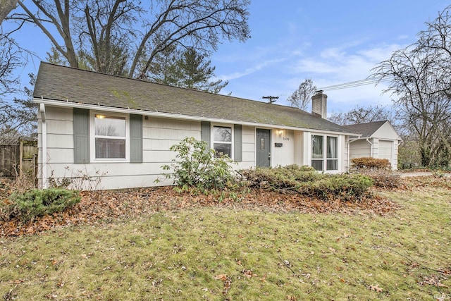 single story home with a front yard and a garage