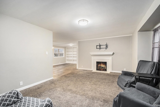 carpeted living room with built in shelves