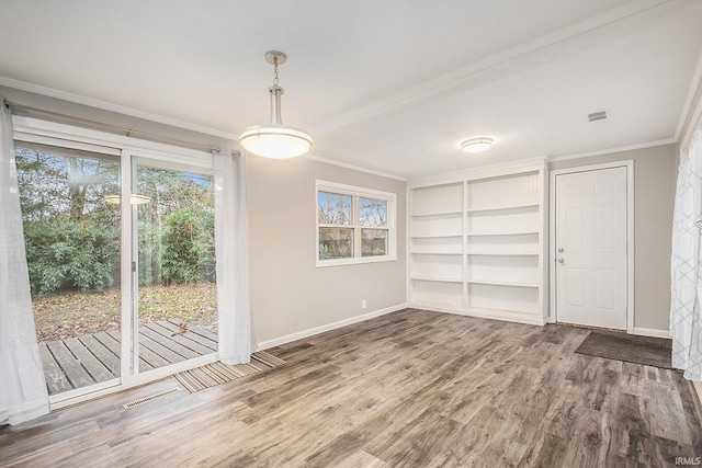 unfurnished dining area with wood-type flooring, built in features, and ornamental molding