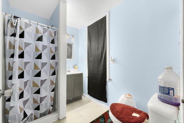 bathroom featuring vanity, toilet, and walk in shower