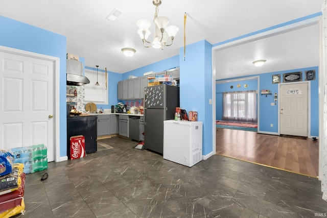 kitchen featuring pendant lighting, a notable chandelier, gray cabinetry, and appliances with stainless steel finishes