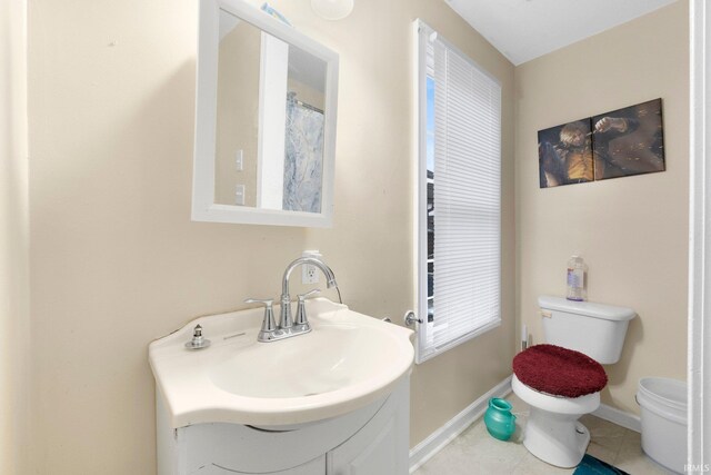 bathroom featuring tile patterned floors, toilet, and sink