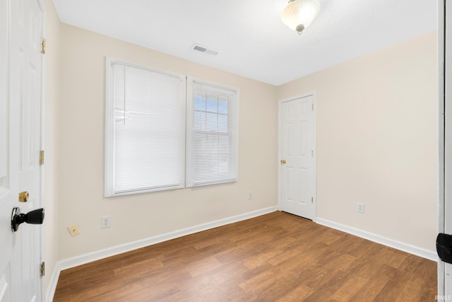 empty room with hardwood / wood-style floors