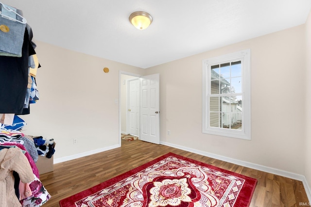 bedroom with dark hardwood / wood-style floors