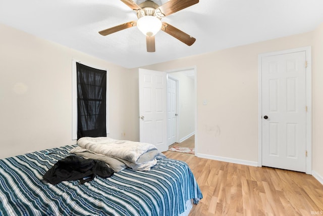 bedroom with ceiling fan and wood-type flooring