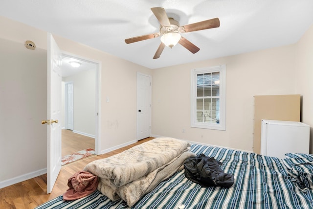 bedroom with ceiling fan and light wood-type flooring