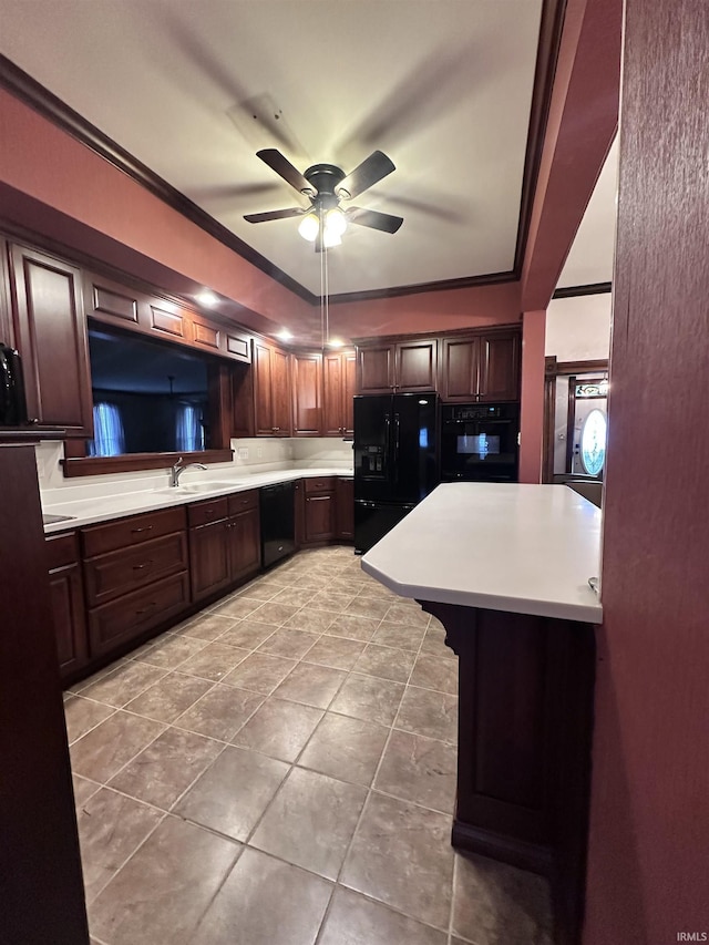 kitchen featuring ceiling fan, sink, crown molding, a kitchen bar, and black appliances