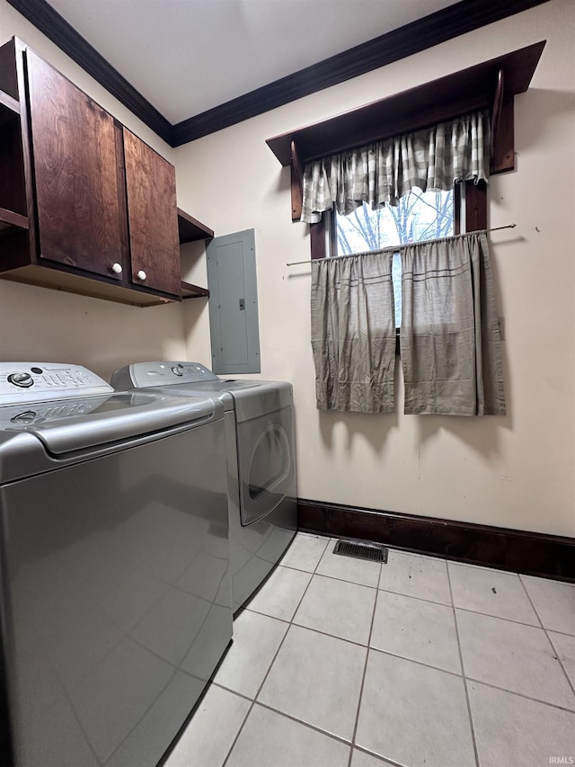 laundry room featuring cabinets, washer and clothes dryer, crown molding, light tile patterned floors, and electric panel