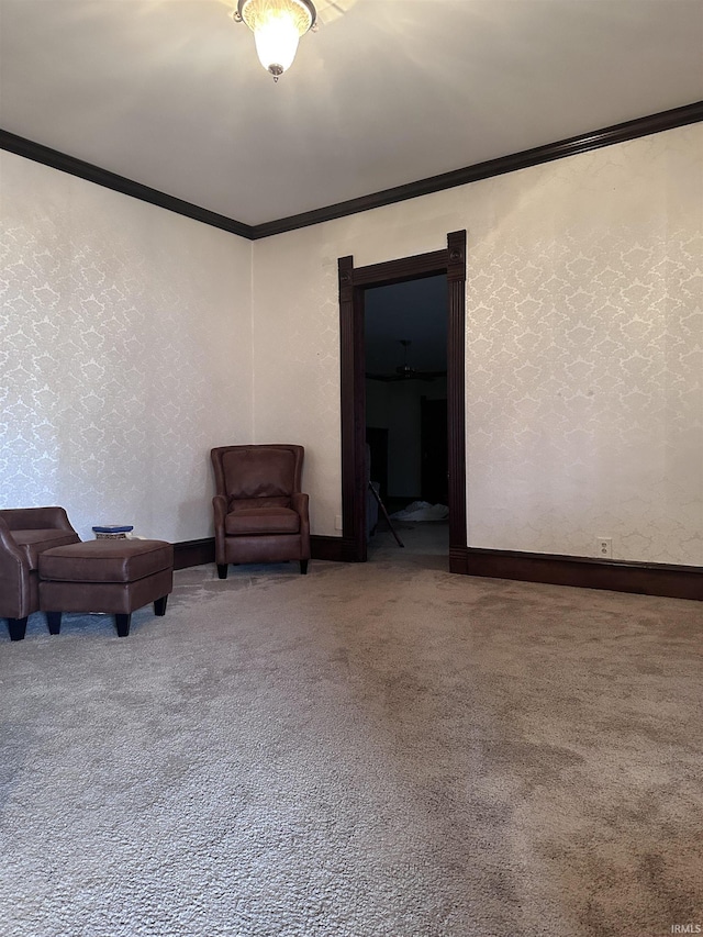 sitting room featuring carpet and crown molding