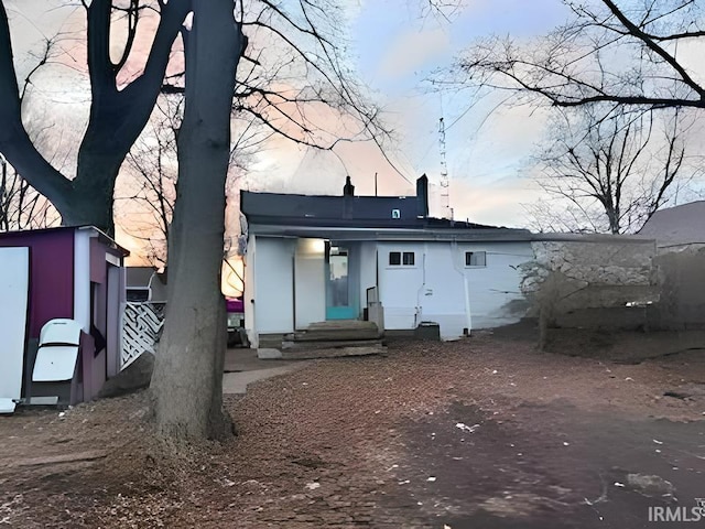 view of back house at dusk