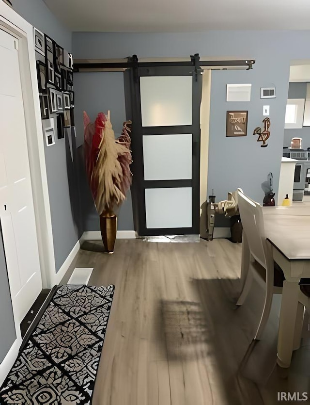 entryway featuring hardwood / wood-style floors and a barn door