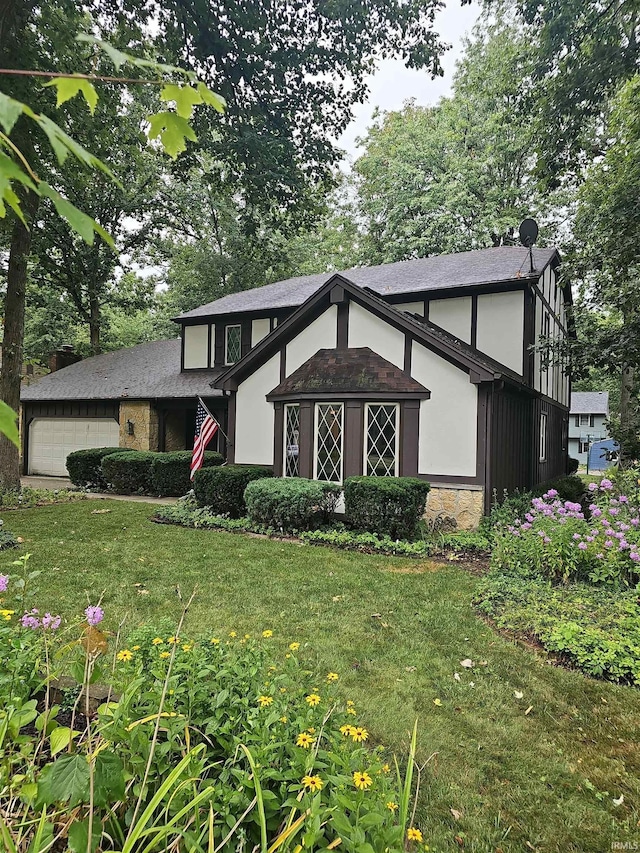 english style home featuring a front yard