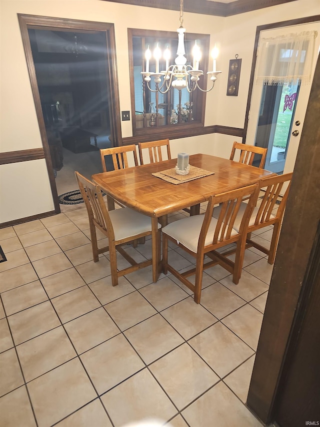 tiled dining room with an inviting chandelier