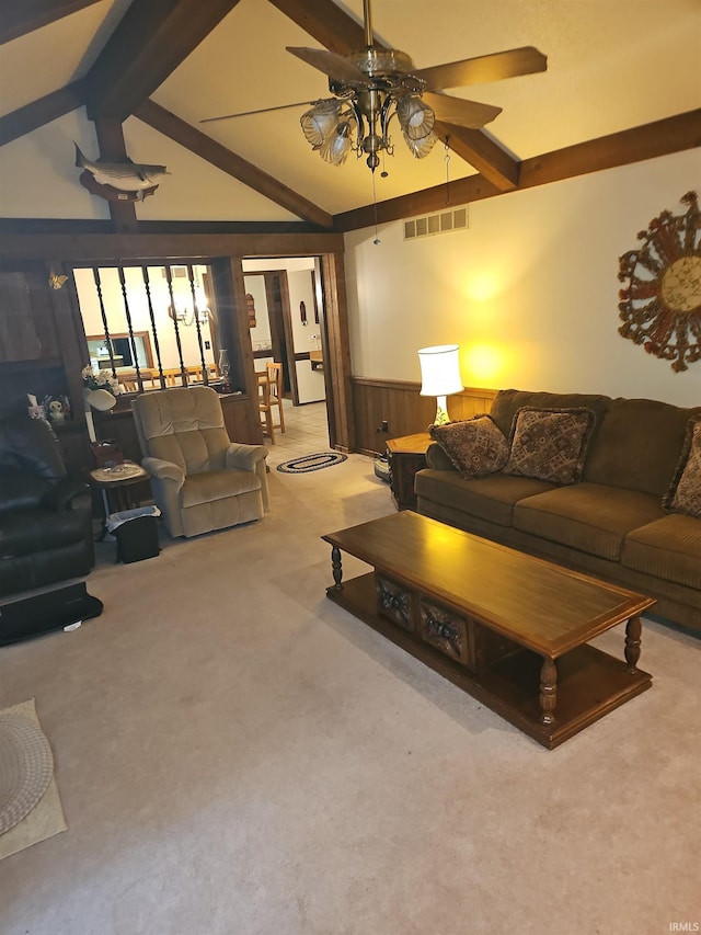 living room featuring wood walls, ceiling fan, lofted ceiling with beams, and light carpet