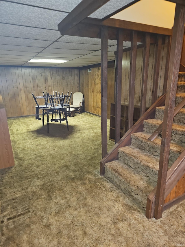 interior space with carpet flooring and wood walls