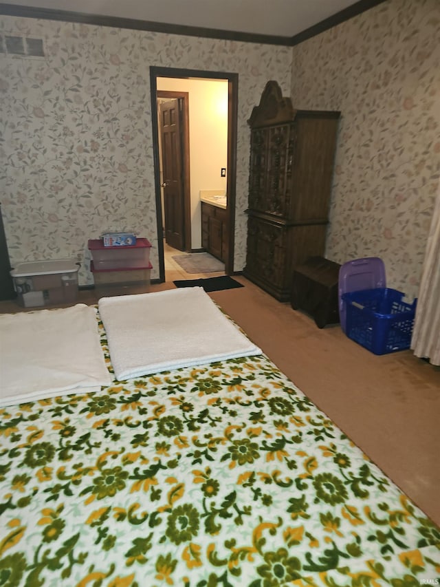 carpeted bedroom featuring connected bathroom and crown molding