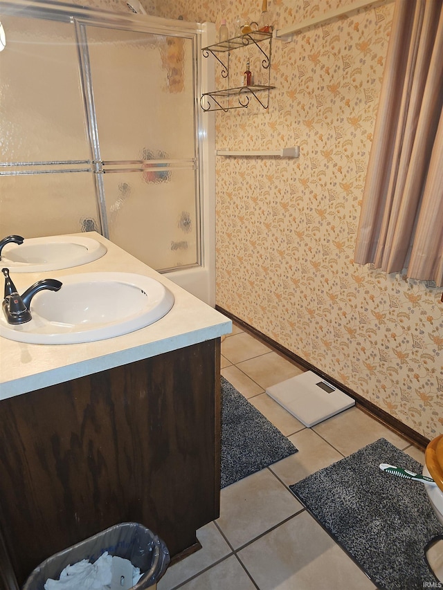 bathroom featuring tile patterned floors, vanity, and bath / shower combo with glass door