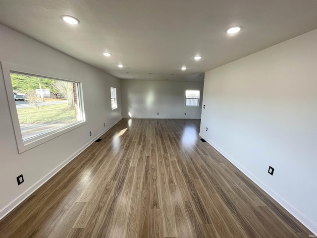 unfurnished living room with dark hardwood / wood-style flooring