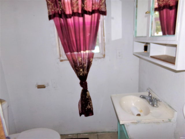 bathroom featuring tile patterned floors, vanity, and toilet