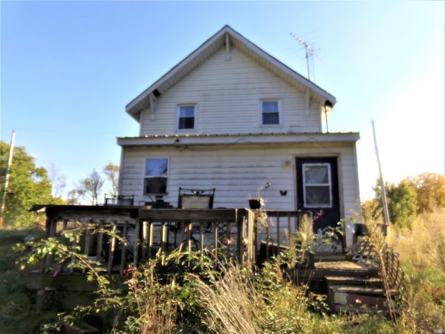 back of property with a wooden deck