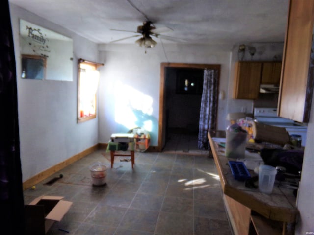 kitchen featuring tile countertops, ceiling fan, and range hood