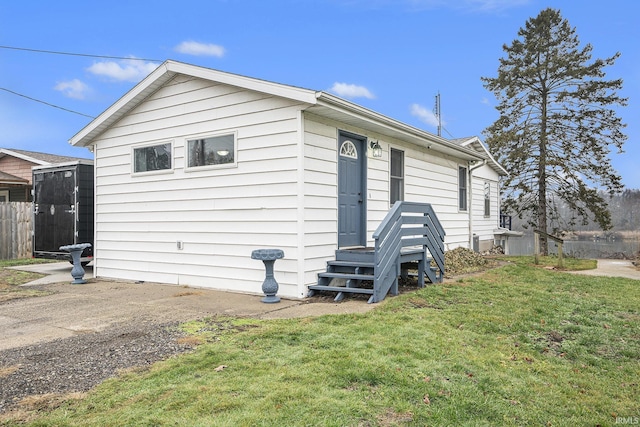 view of side of property with a yard