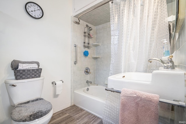 bathroom with shower / tub combo, toilet, and hardwood / wood-style floors