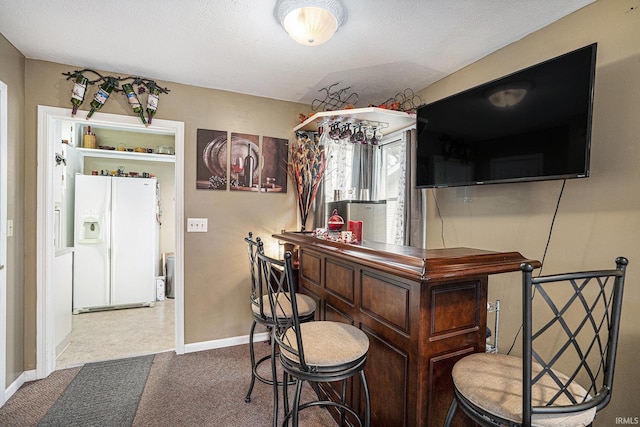 bar with white fridge with ice dispenser and carpet flooring