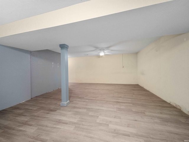 basement with light wood-type flooring and ceiling fan