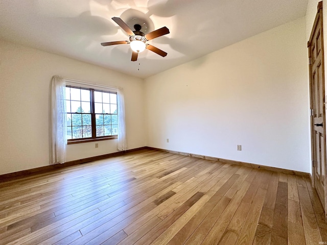 unfurnished room with ceiling fan and light hardwood / wood-style flooring