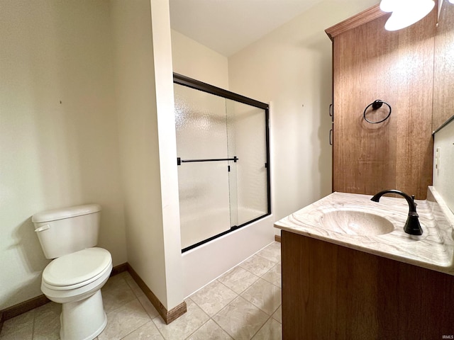 full bathroom with combined bath / shower with glass door, vanity, toilet, and tile patterned flooring