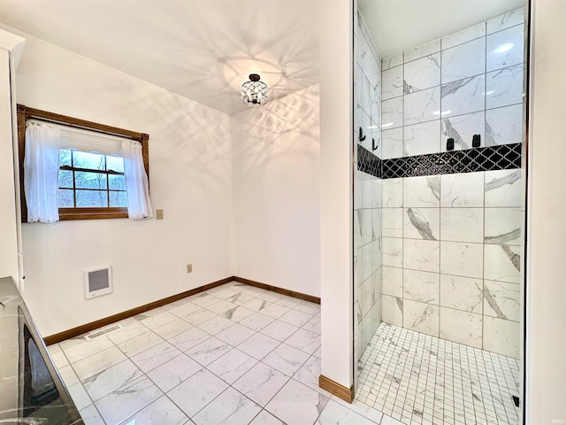 bathroom with a tile shower