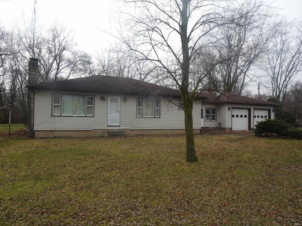 ranch-style house featuring a front yard and a garage