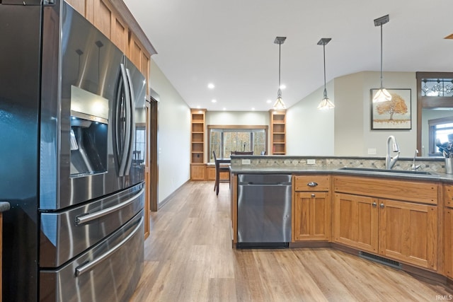 kitchen with sink, hanging light fixtures, light hardwood / wood-style flooring, decorative backsplash, and appliances with stainless steel finishes